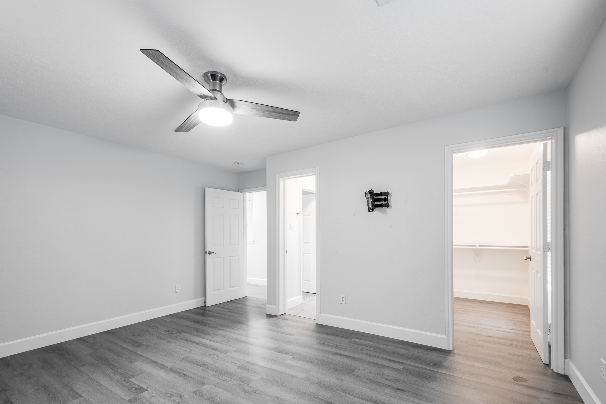 9026 McGallion Road Houston, TX 77022 - Photo 17 of 34 an empty room with wooden floor ceiling fan and windows