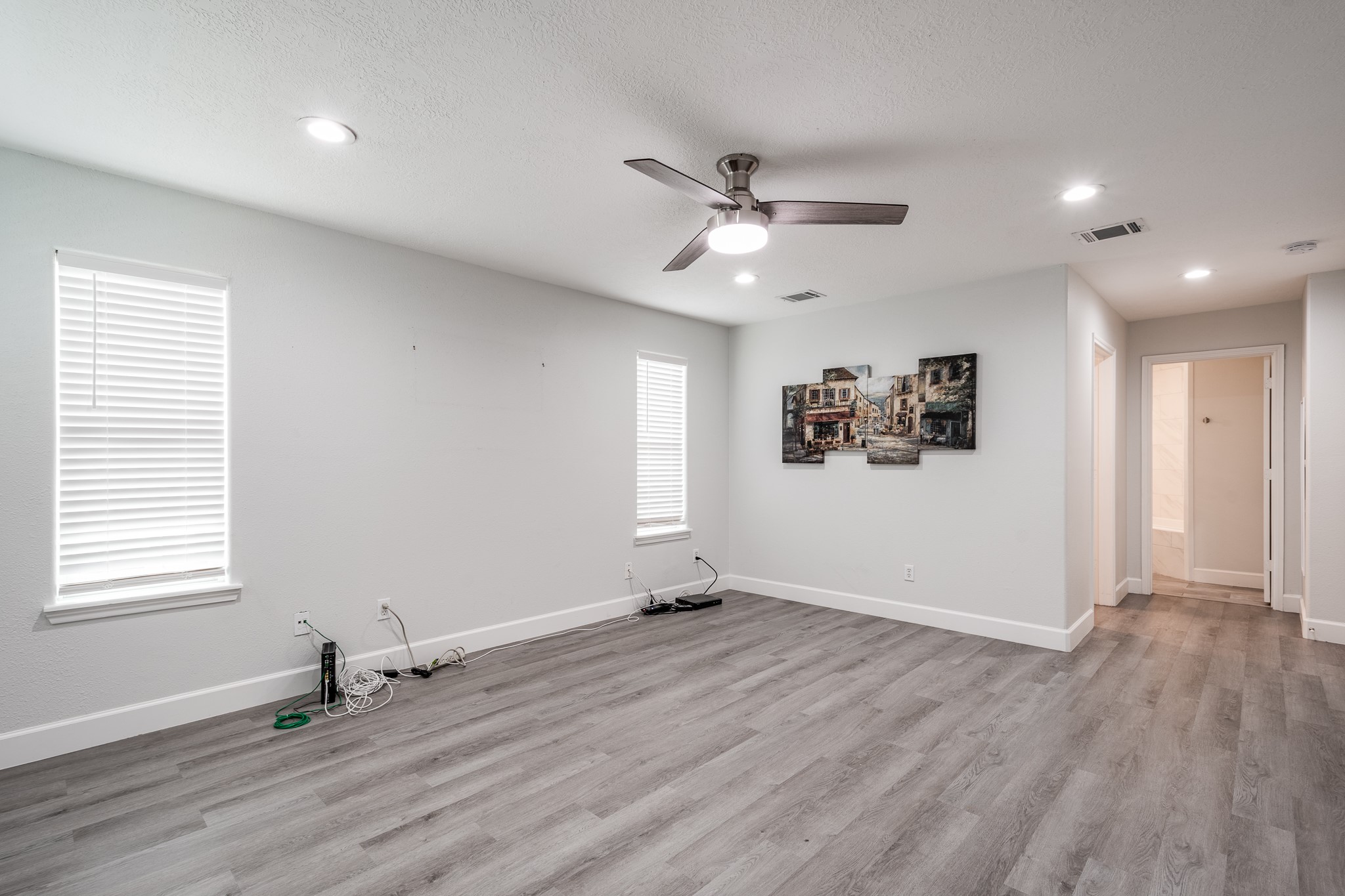 9026 McGallion Road Houston, TX 77022 - Photo 22 of 34 a view of an empty room with wooden floor and a window