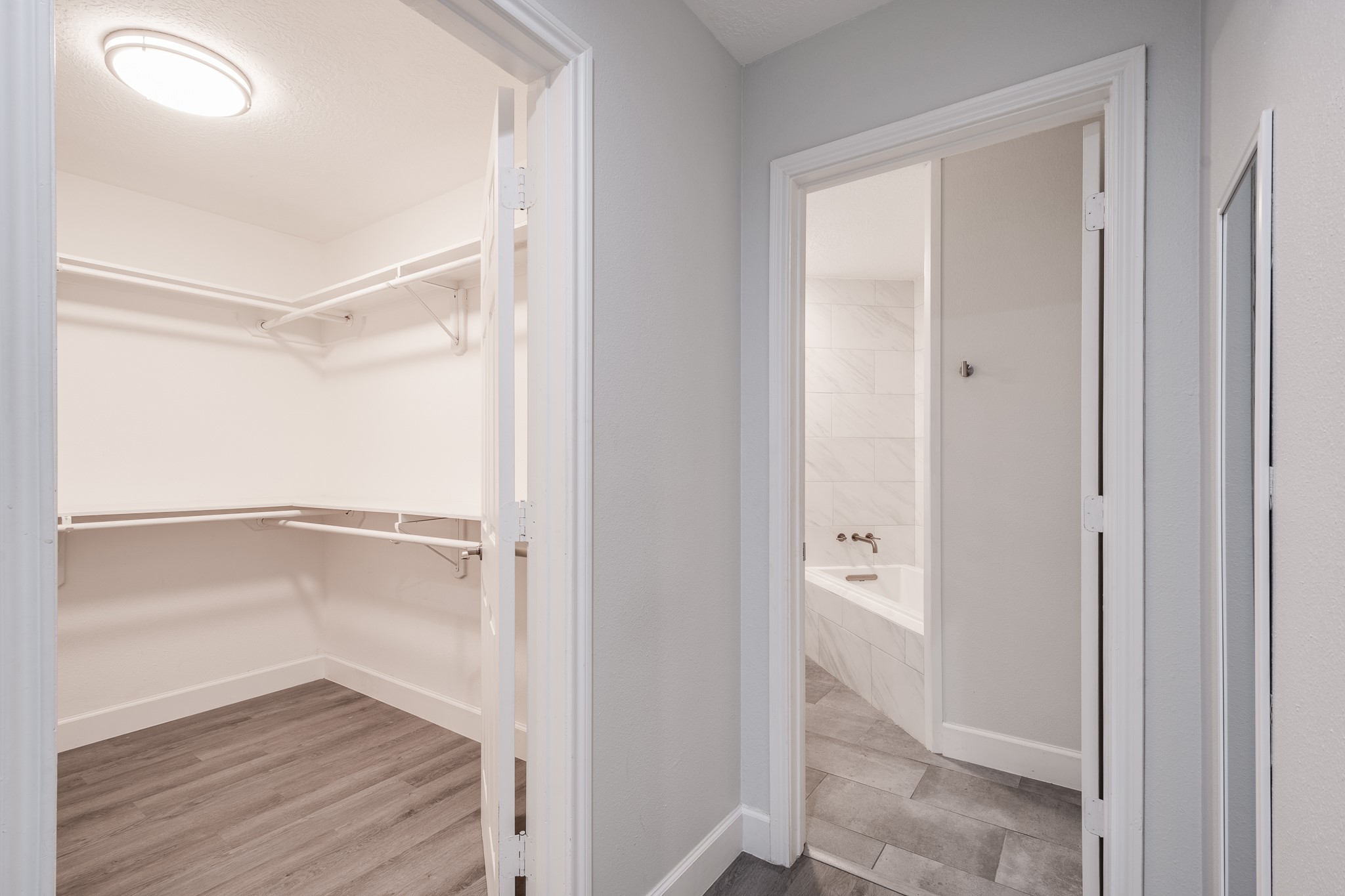 9026 McGallion Road Houston, TX 77022 - Photo 23 of 34 a view of an empty walk in closet with wooden floor