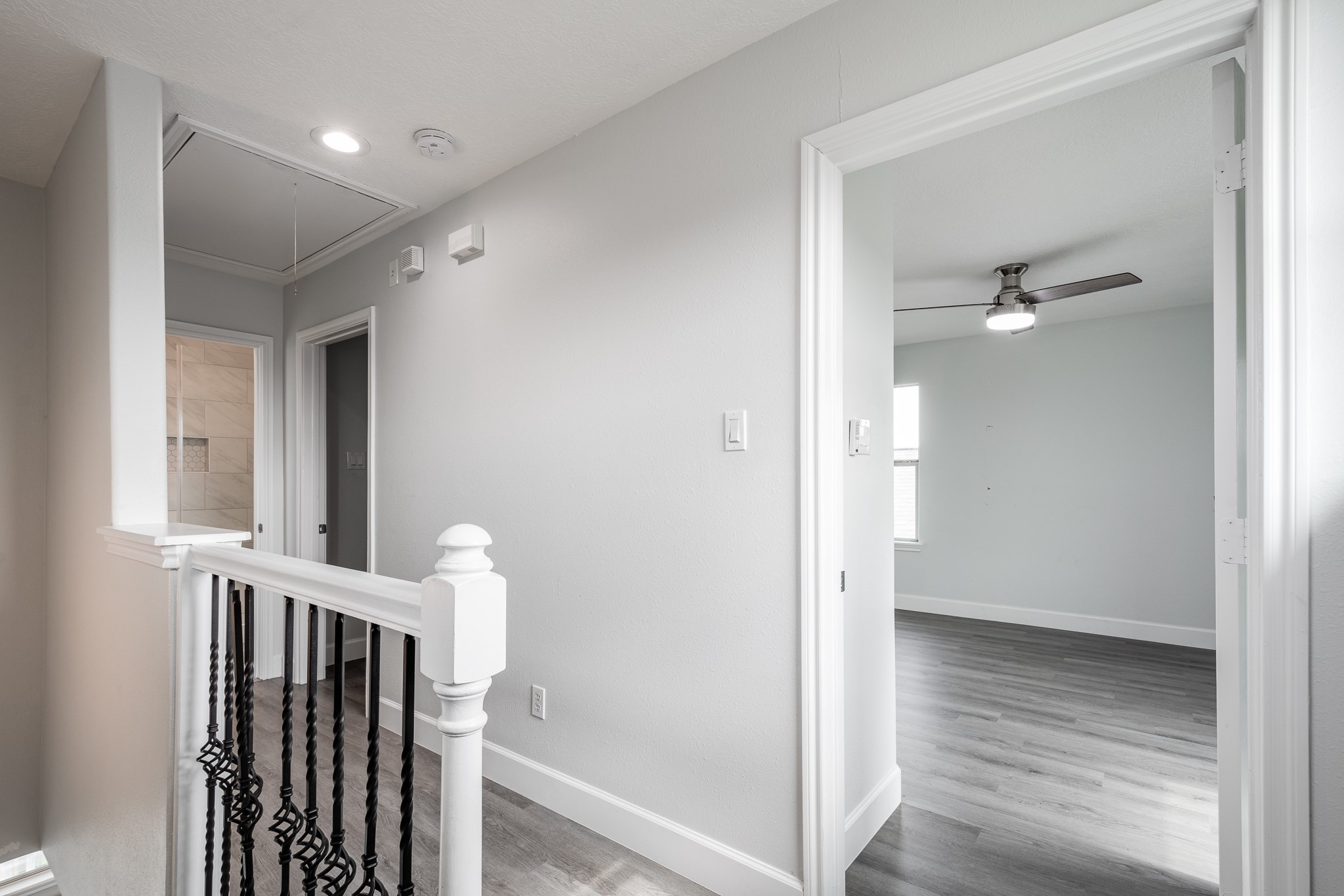 9026 McGallion Road Houston, TX 77022 - Photo 28 of 34 a view of hallway with stairs and a wooden floor