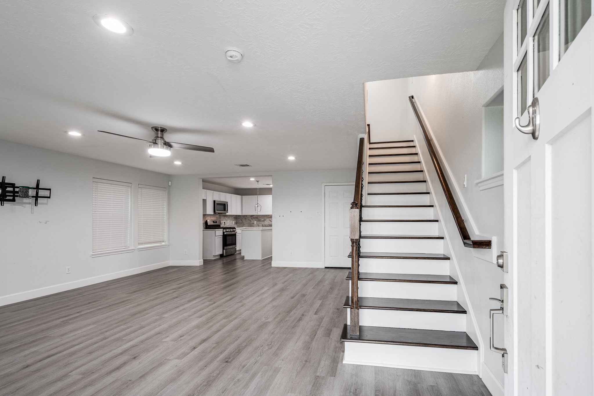 9026 McGallion Road Houston, TX 77022 - Photo 6 of 34 a view of a room with wooden floor and stairs