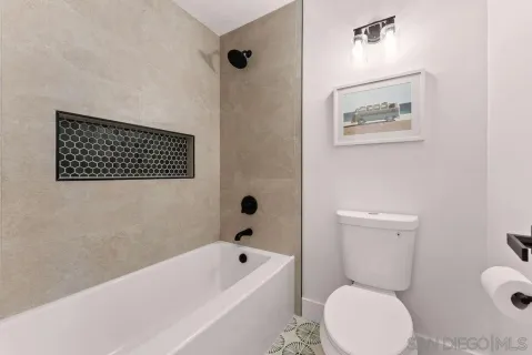 a bathroom with a toilet a sink a bath tub and a shower
