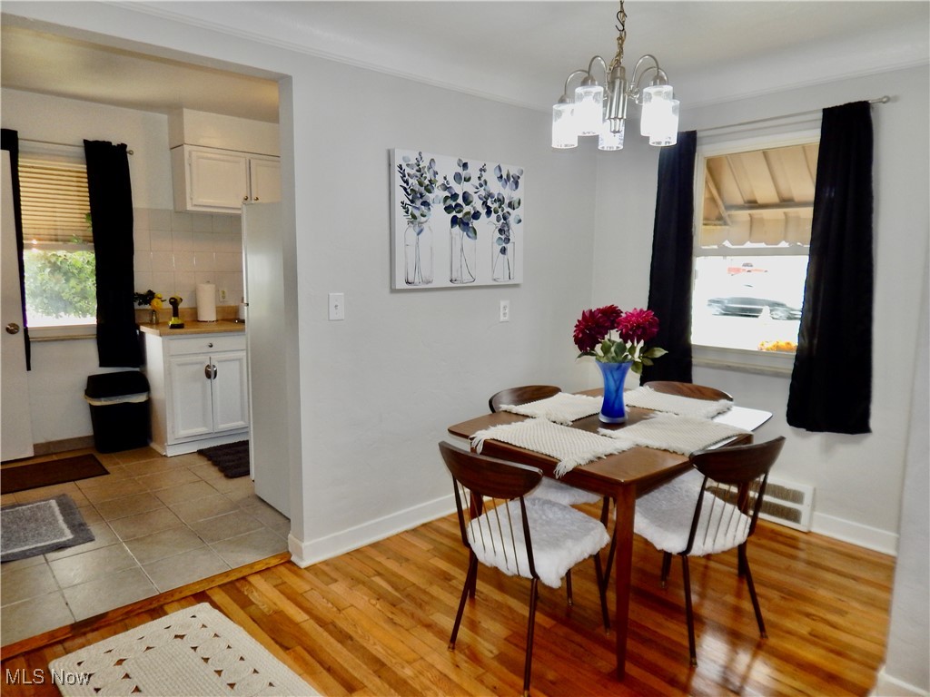 5961 Broadview Road Parma, OH 44134 - Photo 4 of 34 Dining space featuring light hardwood flooring and a chandelier