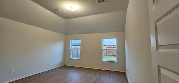 a view of room with window and hardwood floor