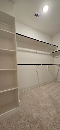 a view of an empty walk in closet