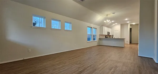 a view of a kitchen with wooden floor and a kitchen