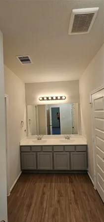 a bathroom with a double vanity sink and mirror