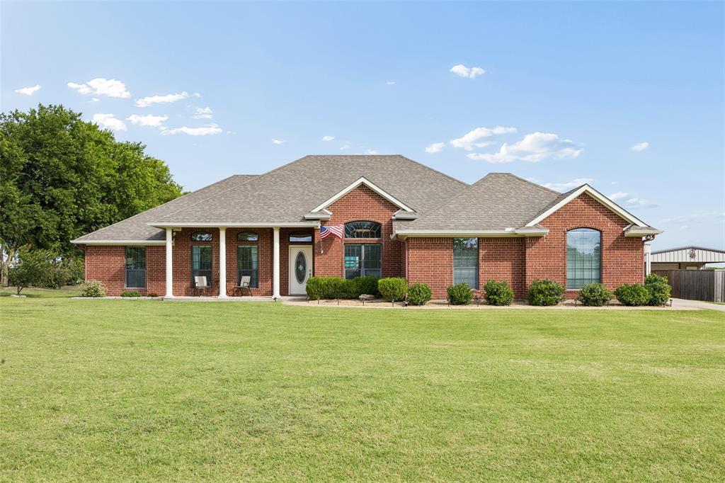 11211 Emerald Ranch Lane Forney, TX 75126 - Photo 12 of 35 Brick exterior residence with a covered porch featuring white columns
