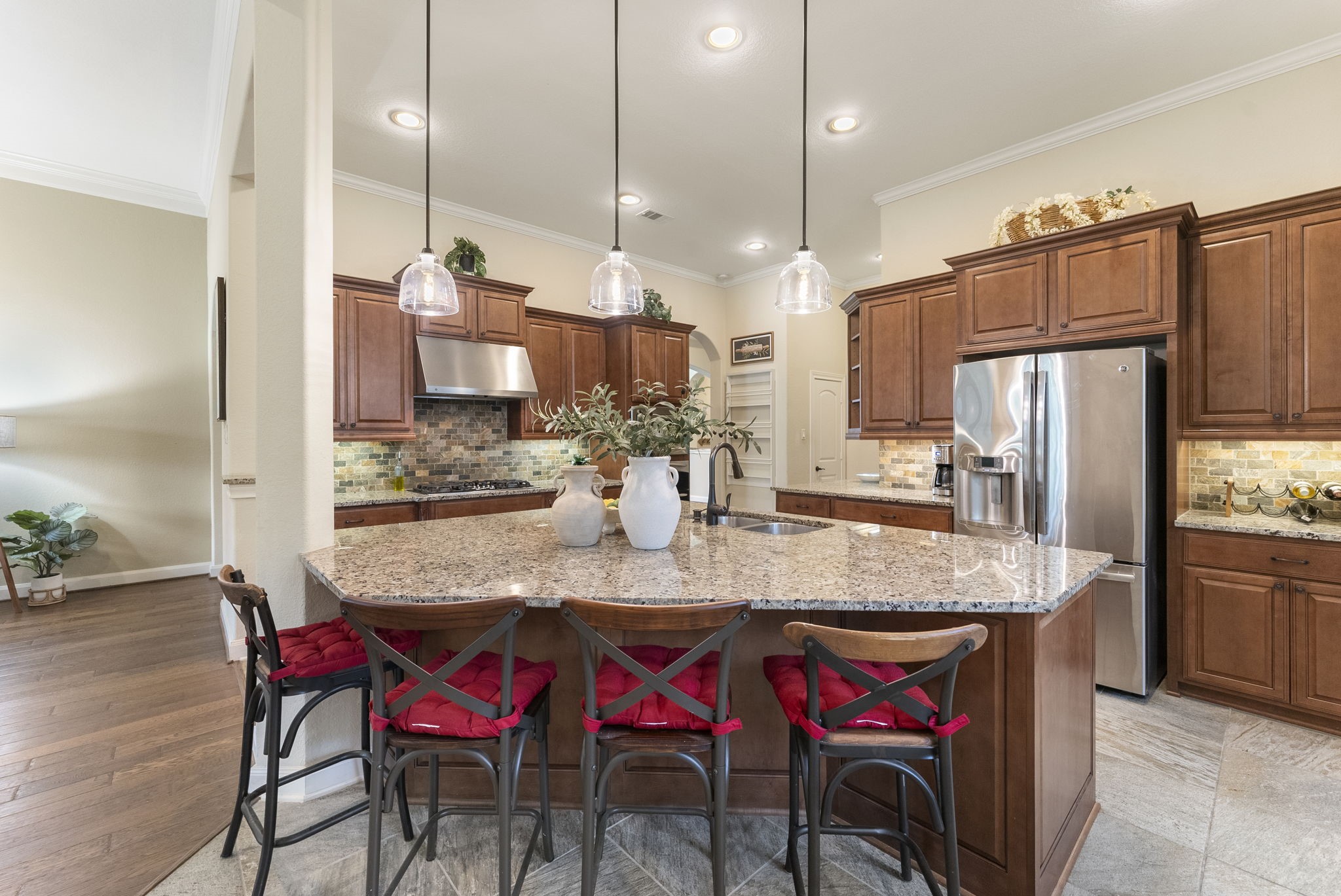 4787 Jackson Square Drive Conroe, TX 77304 - Photo 9 of 35 At the heart of this home lies a stunning island kitchen that effortlessly blends style and functionality. Imagine gathering around the expansive island—perfect for casual breakfasts, evening wine chats, or helping hands during holiday baking.