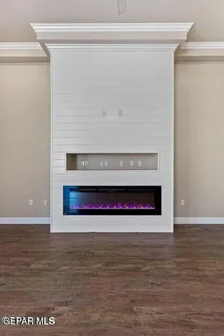 a kitchen with stainless steel appliances granite countertop a refrigerator a sink and wooden floors