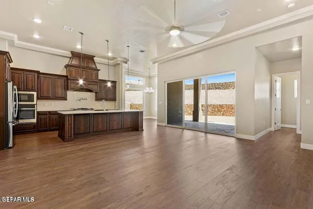 a view of a chandelier in a room with a chandelier fan and wooden floor