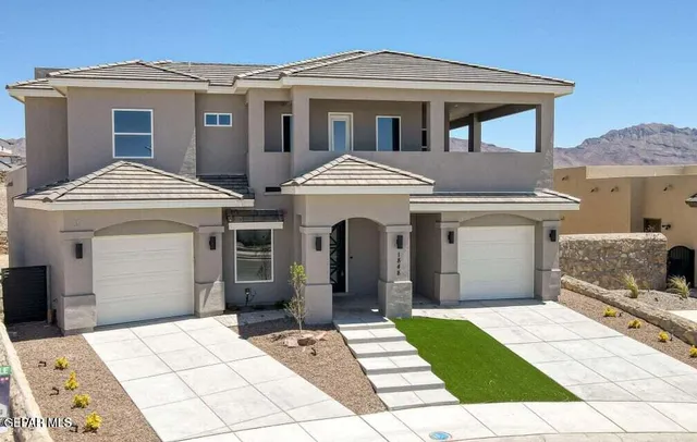 a front view of a house with a garden and a mountain