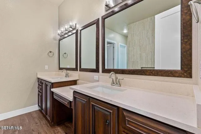 a bedroom with a large bed and a painting on the wall