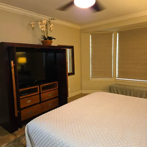 a bedroom with a bed and cabinets