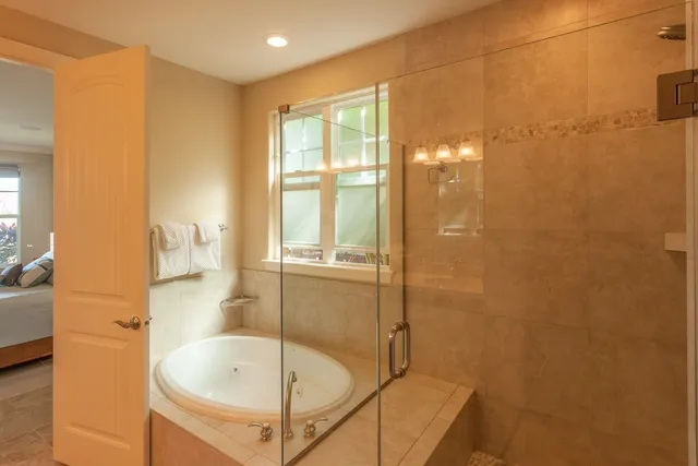 a bathroom with a tub and shower