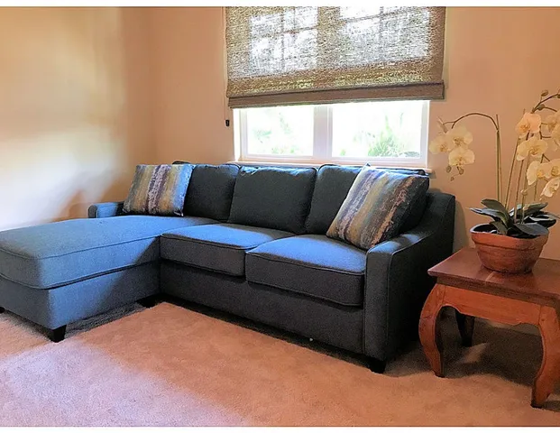a large bed sitting in a bedroom next to a lamp and a chandelier