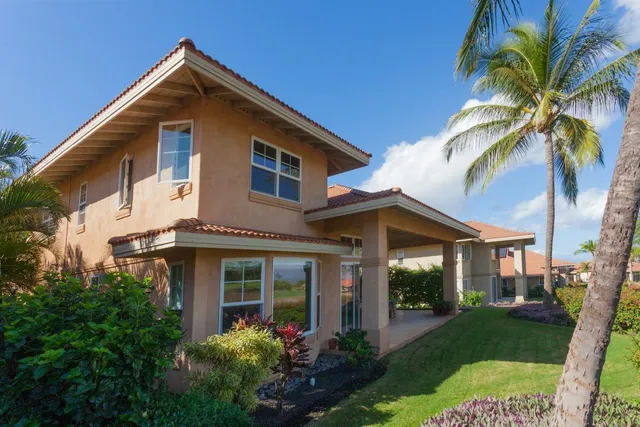 a view of a house with backyard garden and porch