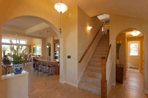 a view of a hallway with entryway wooden floor and windows