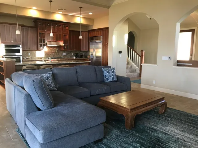 a living room with furniture and kitchen view