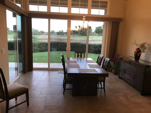 a view of a dining room with furniture window and outside view