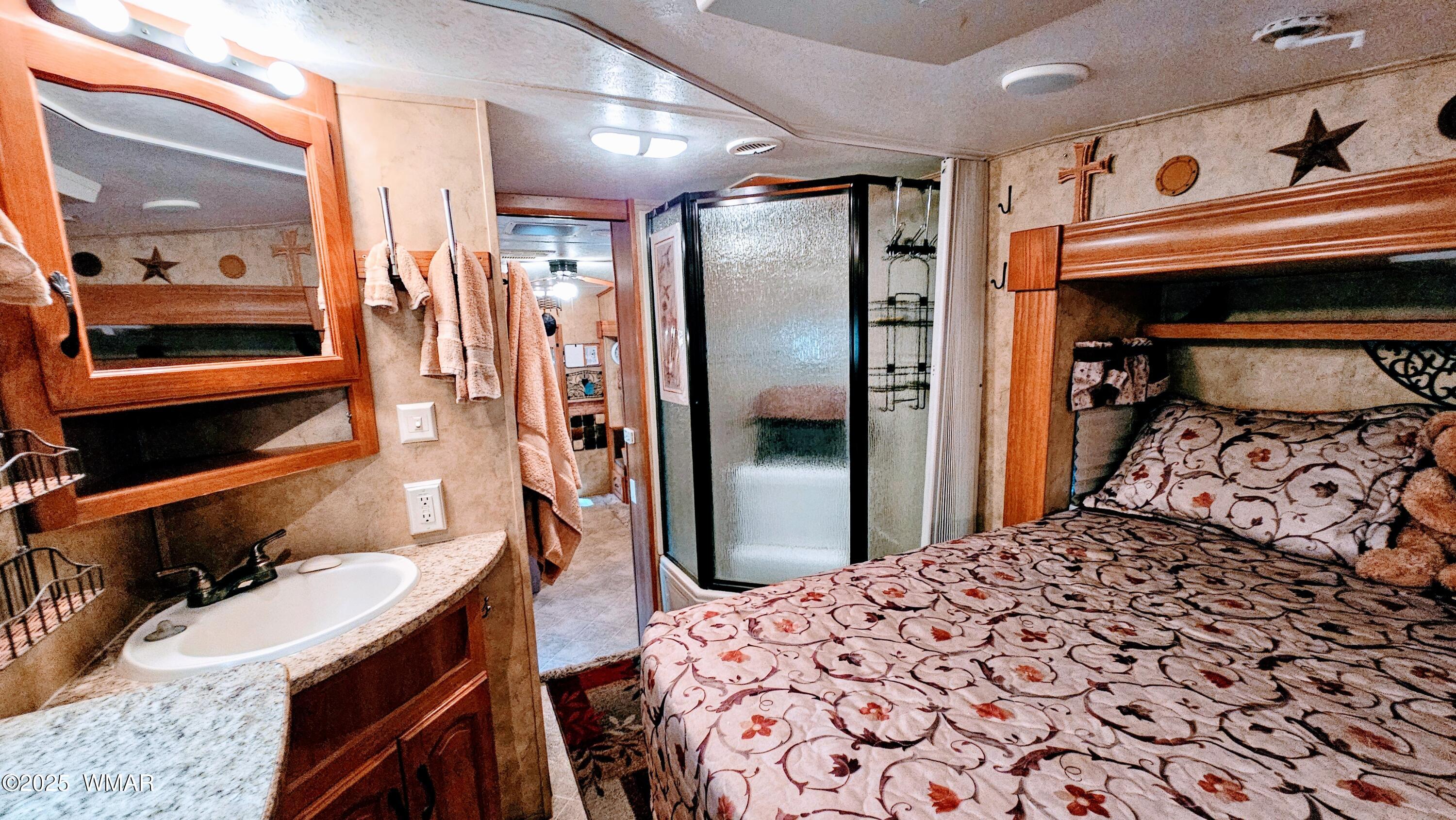 2333 Homestead Road, Unit 61D Lakeside, AZ 85929 - Photo 9 of 13 a bedroom with a bed and a mirror