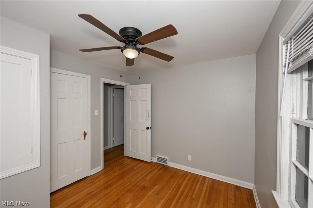 3699 Bainbridge Road Cleveland Heights, OH 44118 - Photo 24 of 37 Room featuring wood-finish flooring, a ceiling fan with integrated lighting, and neutral wall tones