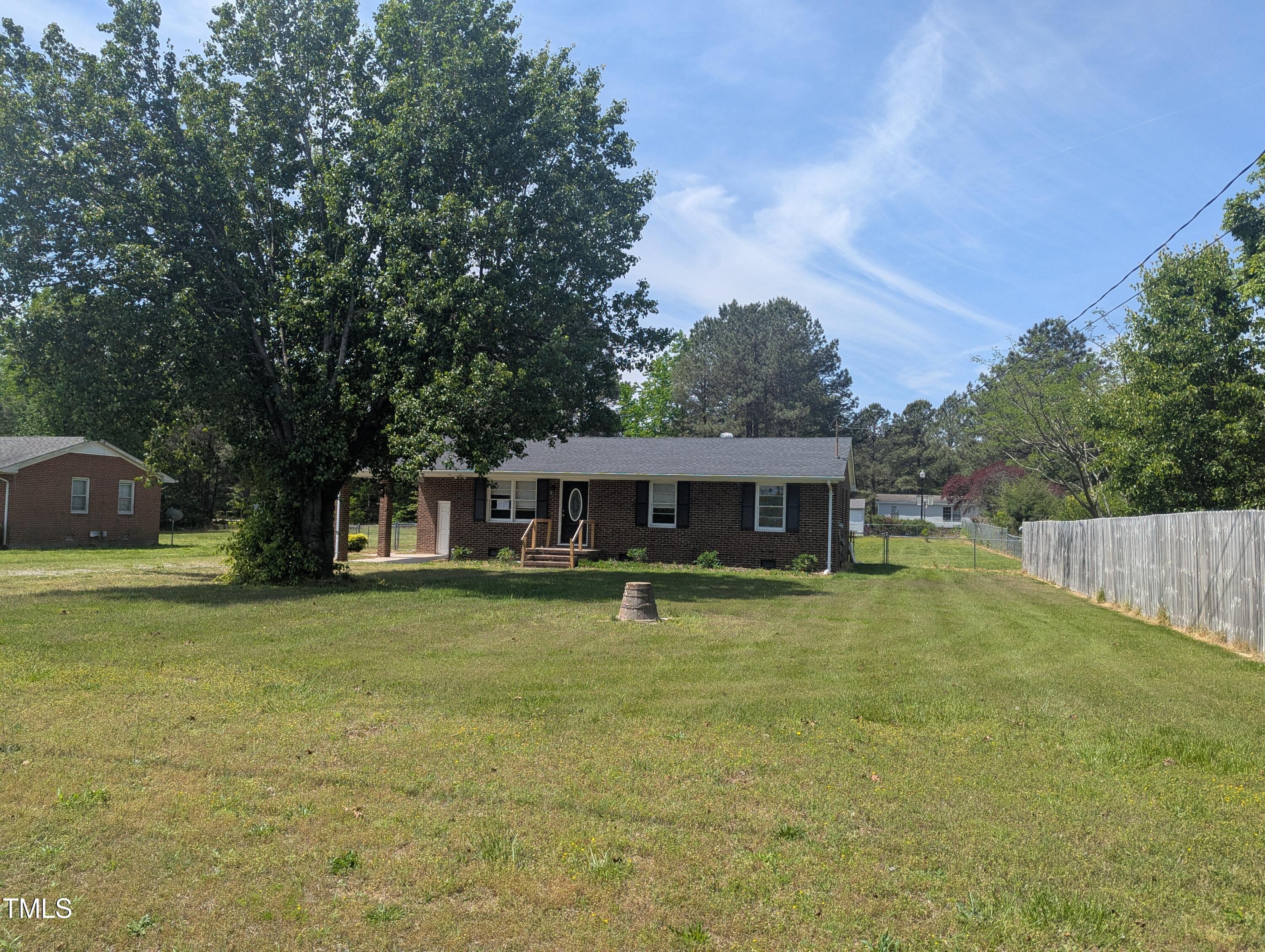 1064 Abbott Road Henderson, NC 27537 - Photo 2 of 9 a backyard of a house with table and chairs