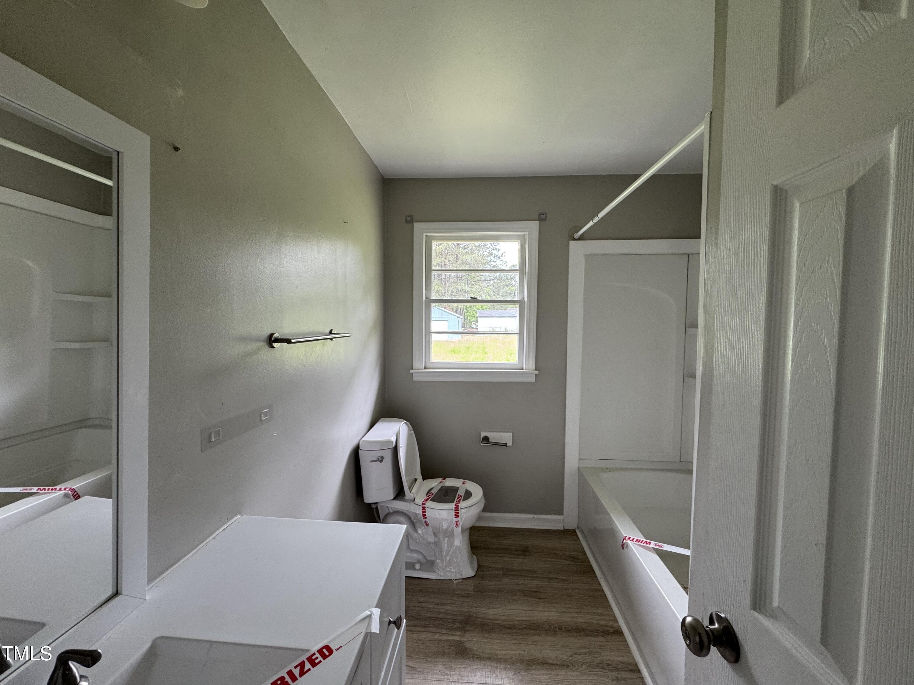 1064 Abbott Road Henderson, NC 27537 - Photo 8 of 9 a bathroom with a sink mirror and toilet