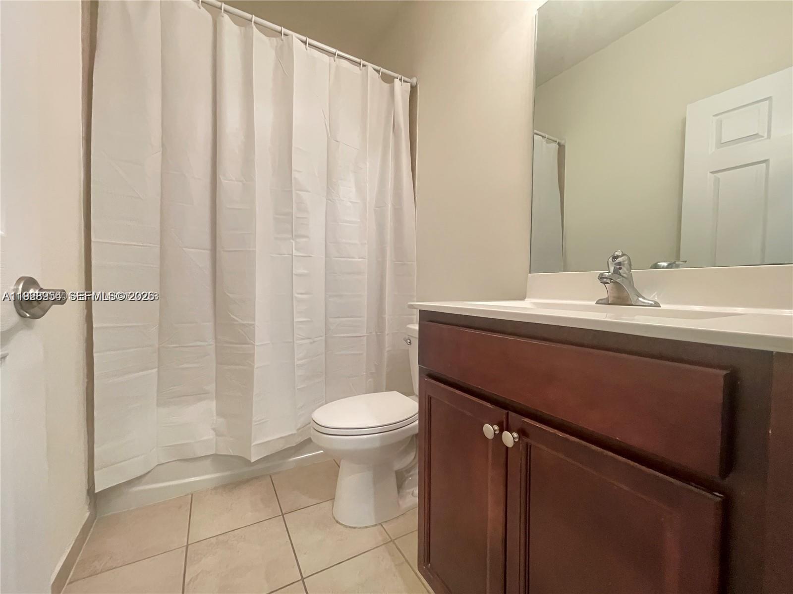 10491 West 34th Court Hialeah, FL 33018 - Photo 14 of 37 a bathroom with a sink a toilet and shower