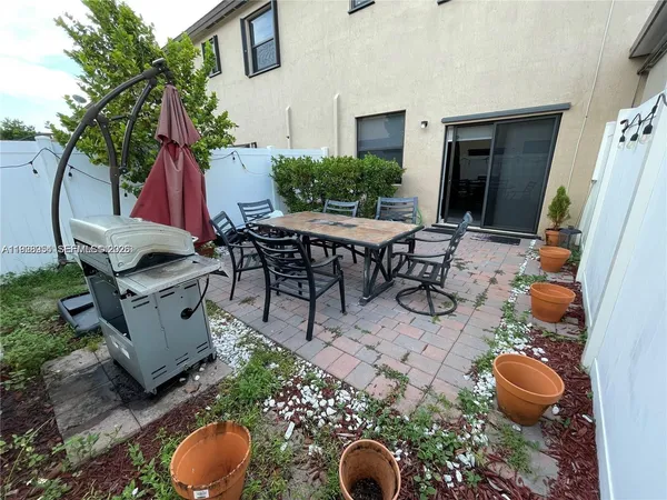 a backyard of a house with outdoor seating