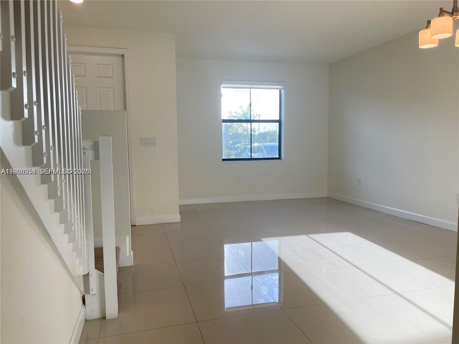 10491 West 34th Court Hialeah, FL 33018 - Photo 2 of 37 an entryway in a hall with a window
