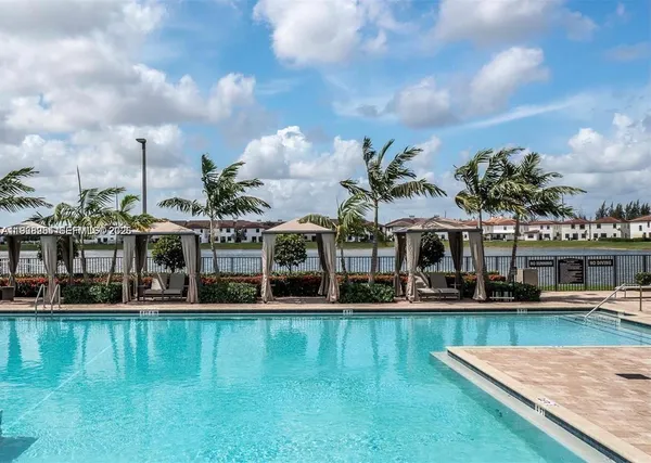 a view of a swimming pool with front of house