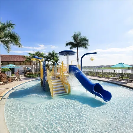 a view of a swimming pool with a patio and a garden