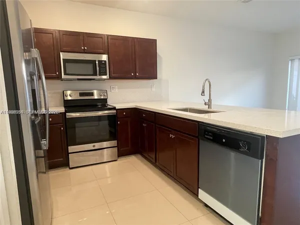 a kitchen with a sink stainless steel appliances and cabinets