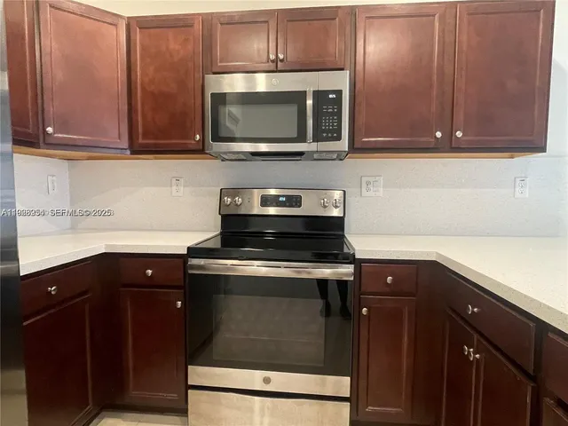 a kitchen with a sink stove and microwave