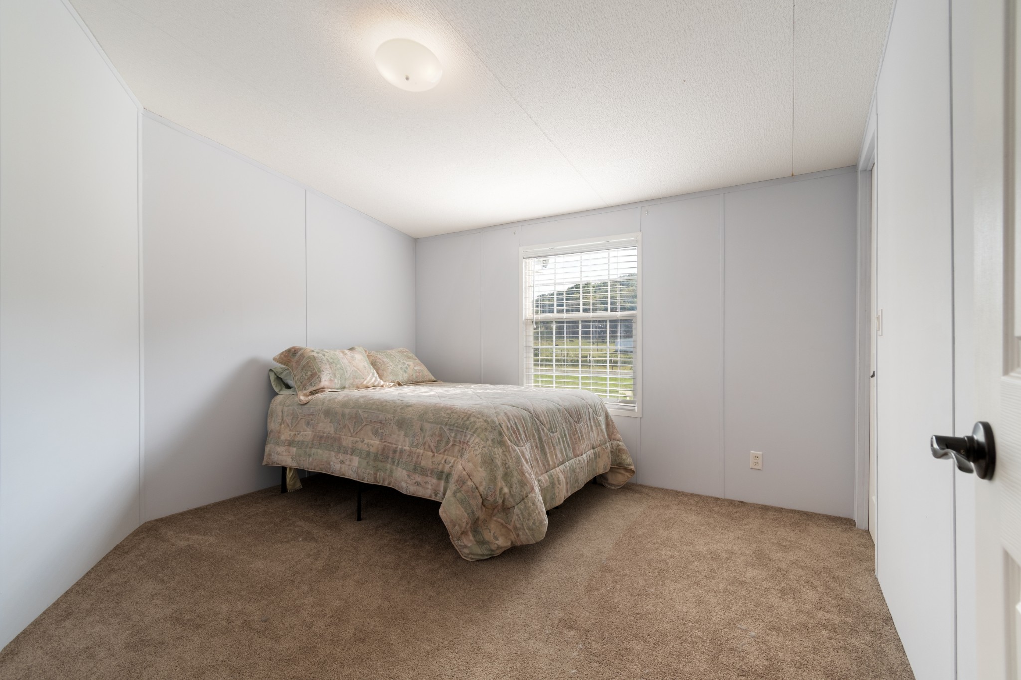 2600 Creecy Hollow Road Pulaski, TN 38478 - Photo 23 of 47 a spacious bedroom with a bed and a window