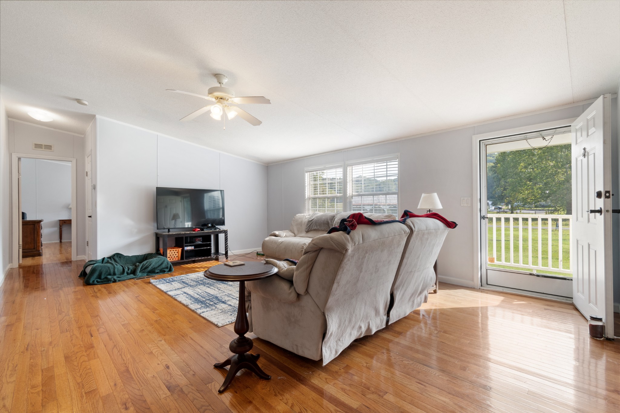 2600 Creecy Hollow Road Pulaski, TN 38478 - Photo 9 of 47 a living room with furniture a flat screen tv and a large window