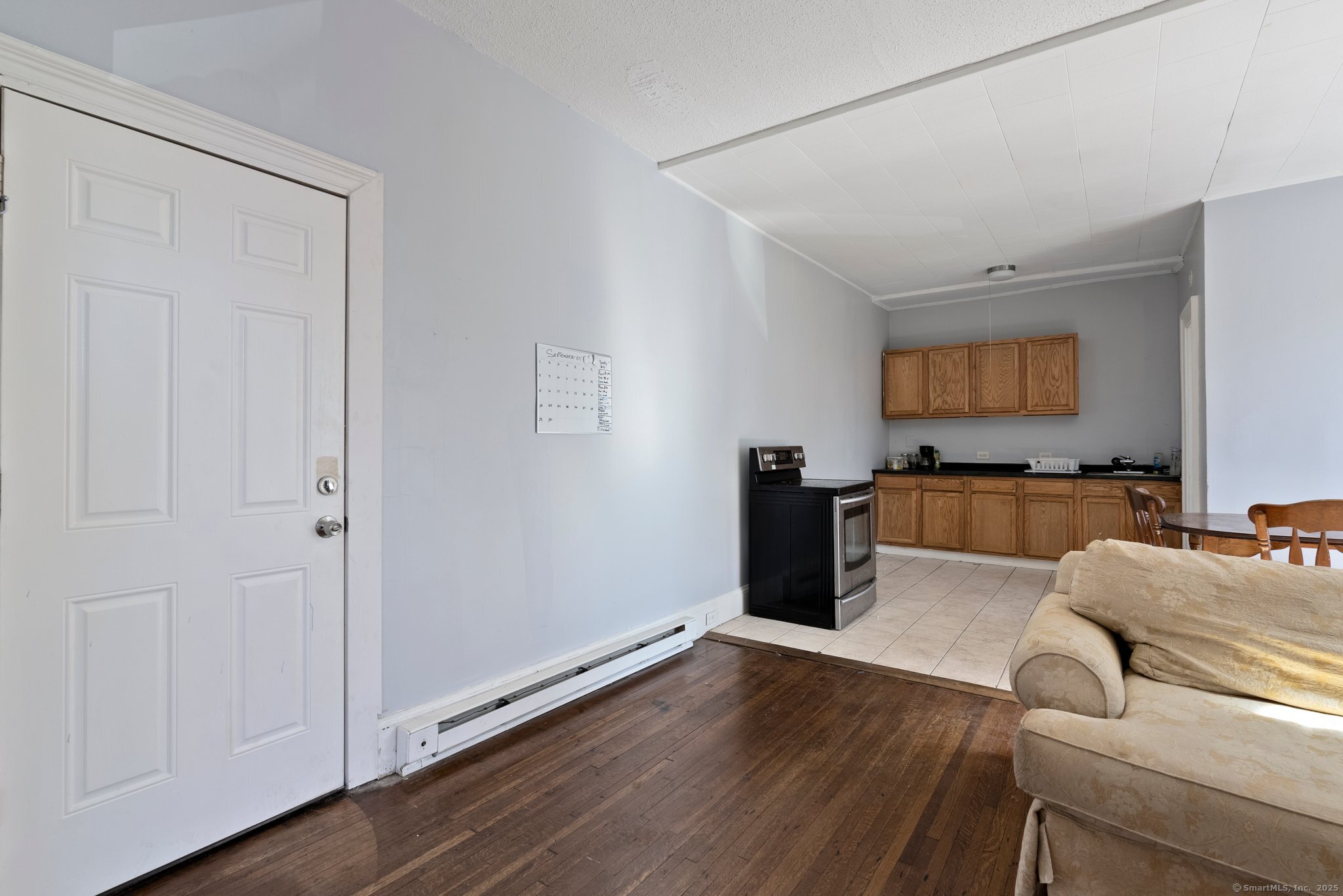 160 Prospect Street, Unit 1 Waterbury, CT 06710 - Photo 5 of 13 a living room with furniture and a flat screen tv