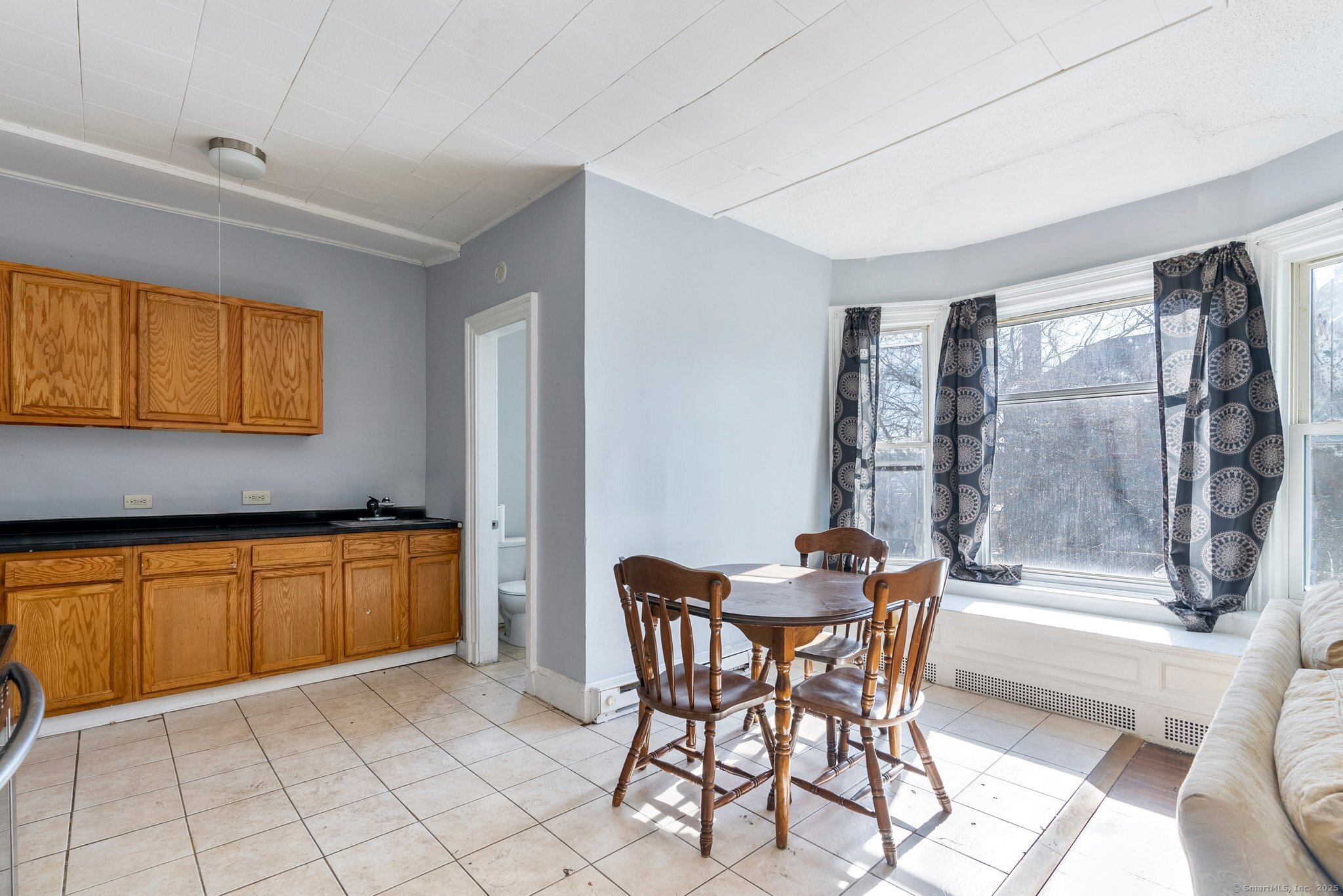 160 Prospect Street, Unit 1 Waterbury, CT 06710 - Photo 6 of 13 a dining room with a sink and a refrigerator