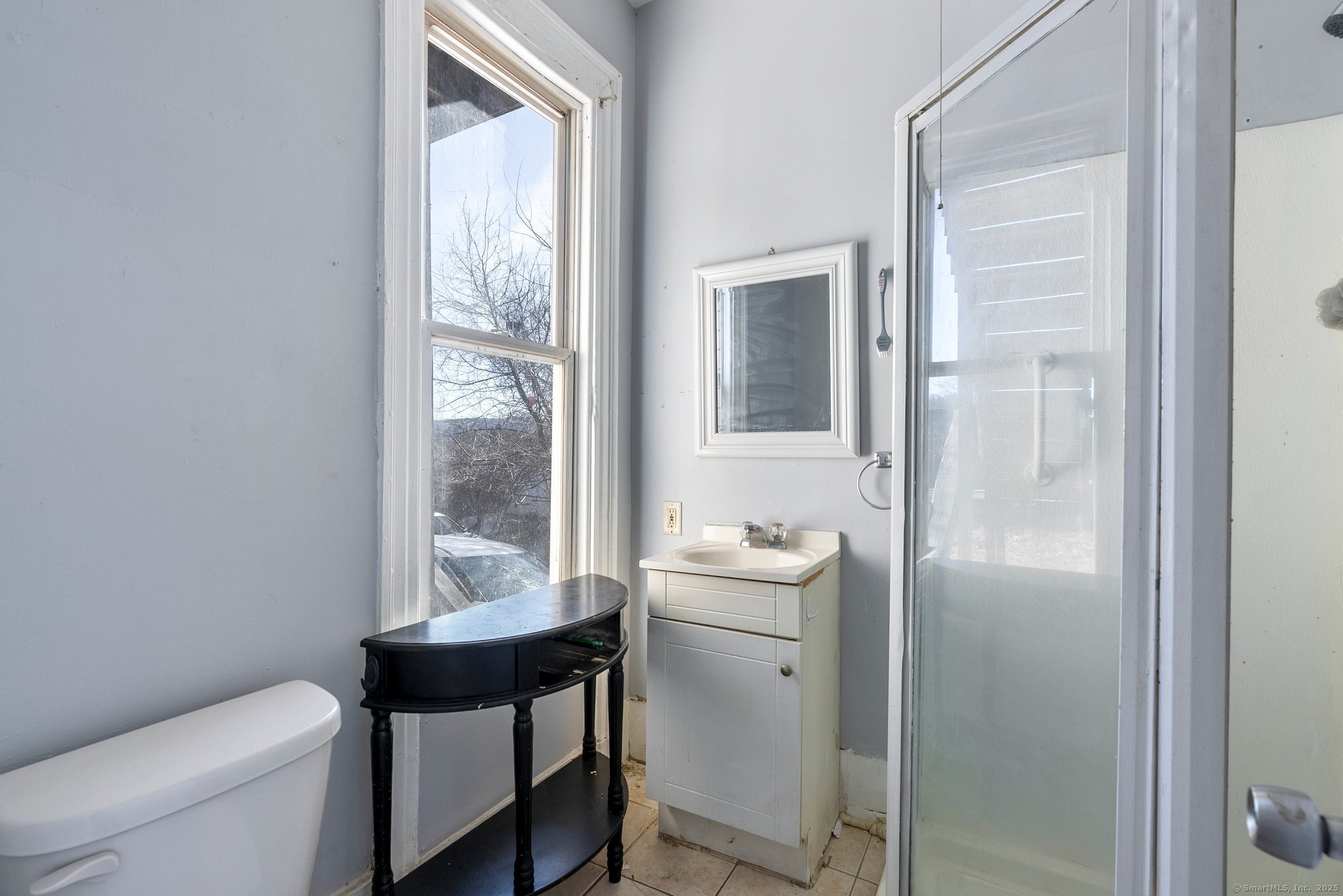 160 Prospect Street, Unit 1 Waterbury, CT 06710 - Photo 7 of 13 a bathroom with a sink toilet and a mirror