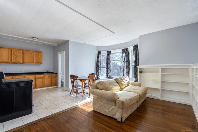 a bedroom with a bed and a table chair