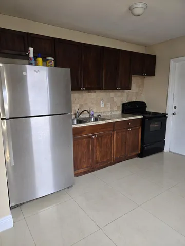 a white refrigerator freezer sitting in a kitchen