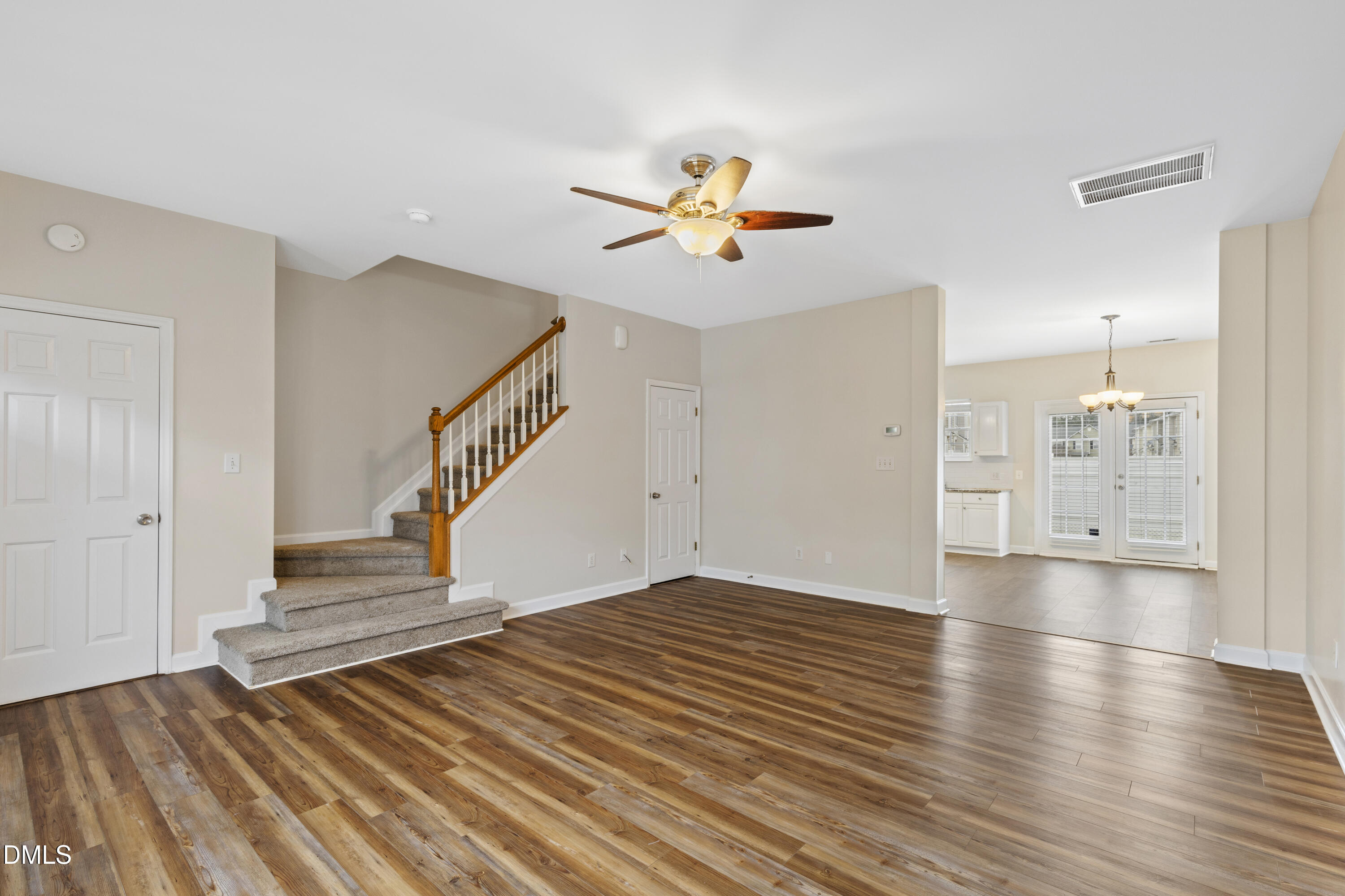 6013 San Marcos Way Raleigh, NC 27616 - Photo 6 of 21 a view of a livingroom with wooden floor and a ceiling fan