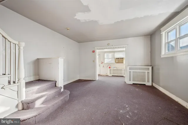 an empty room with a empty space and windows