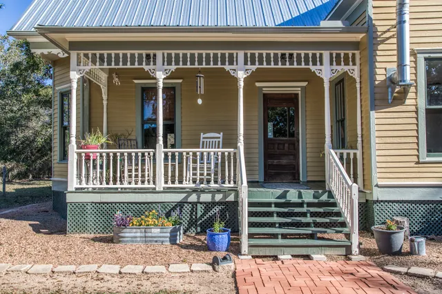 a dining room with furniture a rug and a painting