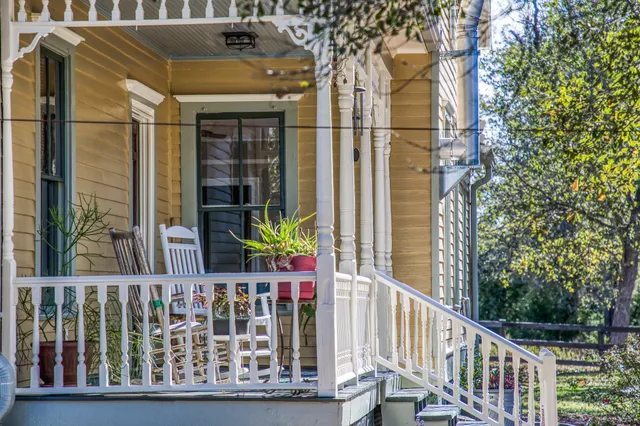 a bedroom with a bed and a dresser with wooden floor