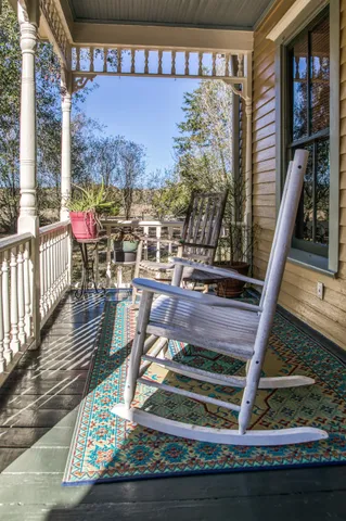 a living room with furniture hard wood floor and a book shelf