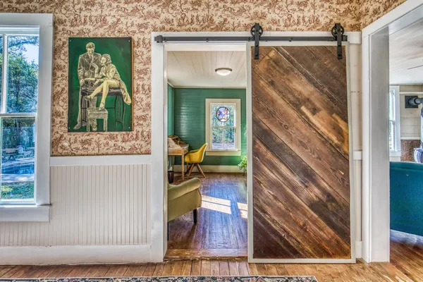 a dining room with furniture a rug and a painting