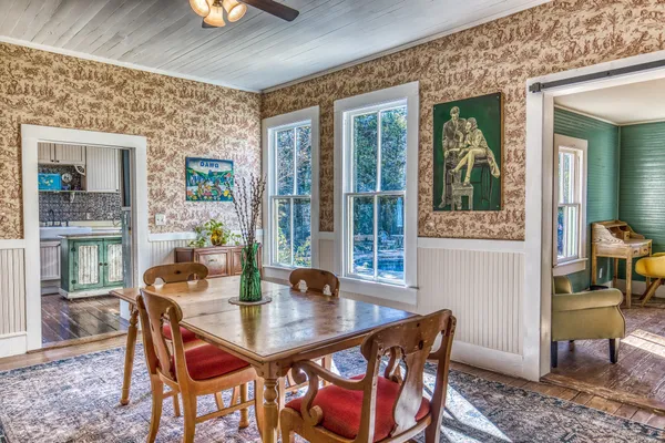 a view of hallway with livingroom and wooden floor