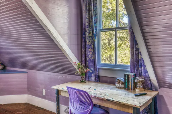 a living room with furniture hard wood floor and a book shelf